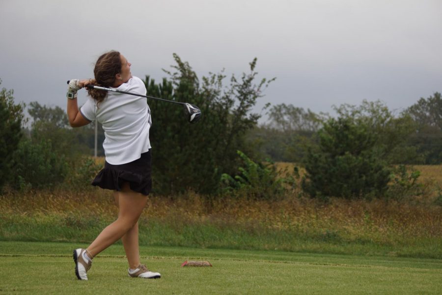 Senior Sydney Rhodes drives a ball towards to the green. Rhodes qualified for state and will be competing Oct. 21.