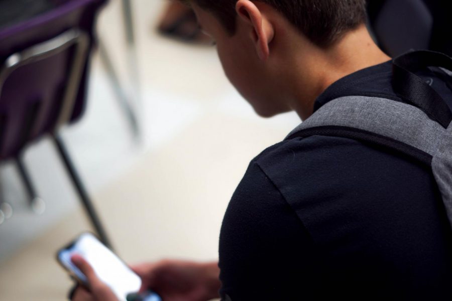 Sophomore Nathan Hiatt texts while in class.