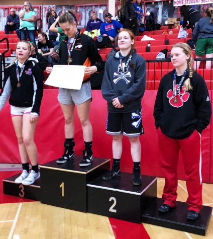 Junior Sara Lake takes her spot on the podium for second place at the Kansas High School Girls Wrestling State Championship