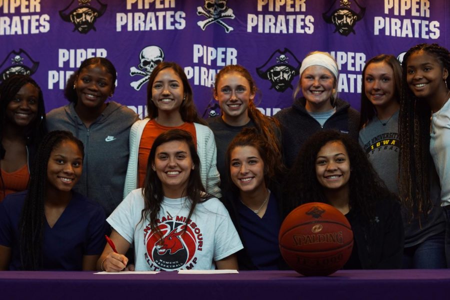 Senior Alison Vigil is joined by her Lady Pirates teammates as she signs to play for the University of Central Missouri on Nov 13.  