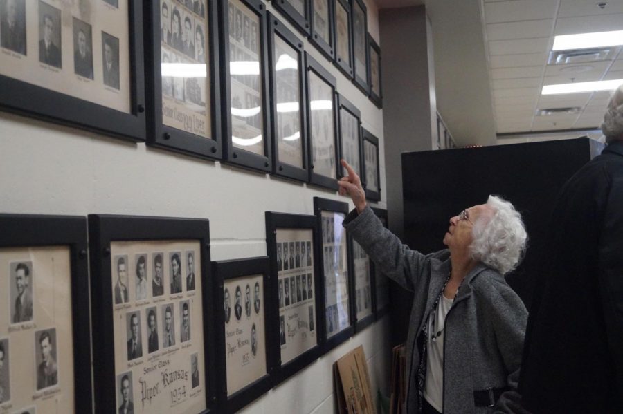 Alumni Marge Scott-Englehart looks at her class pictures and points out her former classmates.