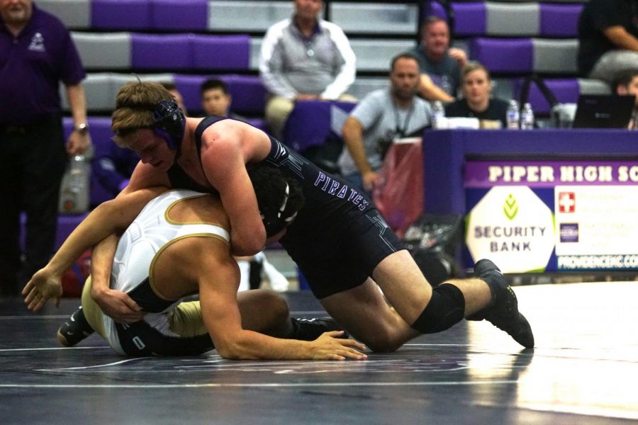 Junior Branden Martin pins his opponent at the Piper meet.