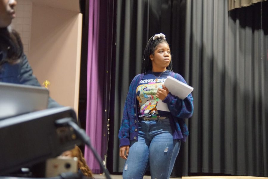 Junior Jennifer Obiesie helps run the Jeopardy game played at the January meeting.