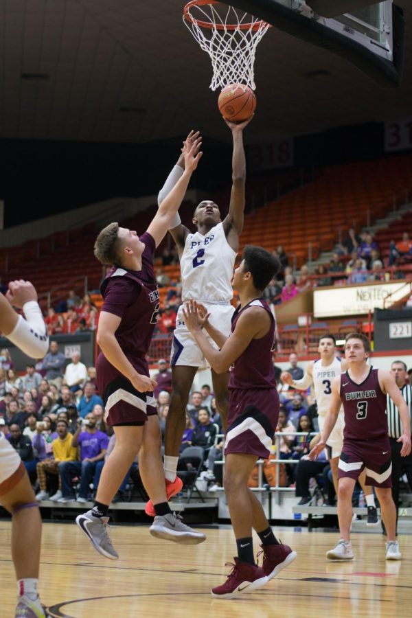 Hoping to advance their lead, junior Tamar Bates goes up for a jump shot. Bates nearly fouled out of the game with four fouls in the fourth quarter.