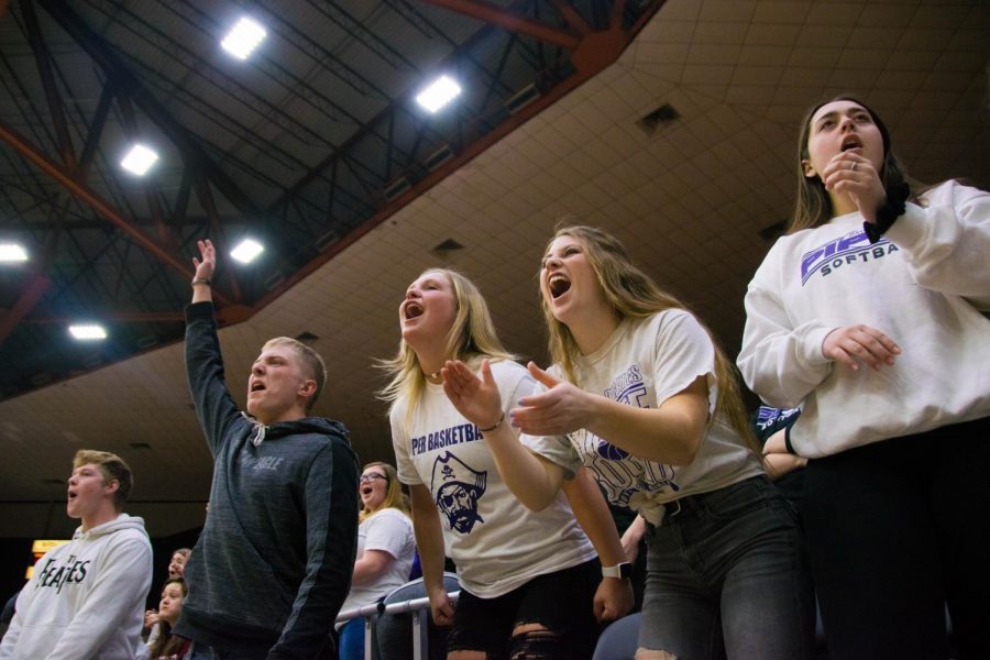 Junior Aiden Price and seniors Bella Gravatt and Emma Martin cheer for senior Alison Vigil after she drops a three. Vigil often appreciates the energy the Pirates bring. "Once a play is dead, a timeout is call, or the clock runs down I like to look over at the crowd and play off their energy," Vigil said. "They help me set the tone for the game and the hyper and energetic they are the more fun it is on the court."