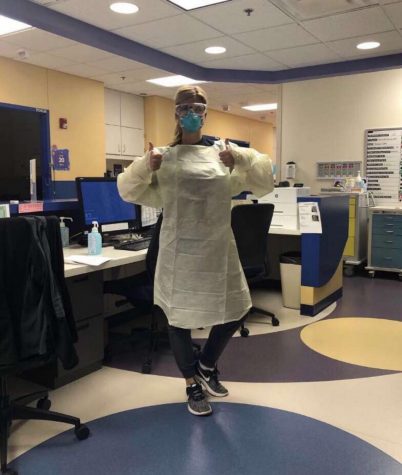 Dressed in personal protective equipment from head to toe, pediatric nurse Andrea Serrano works during the COVID-19 pandemic.