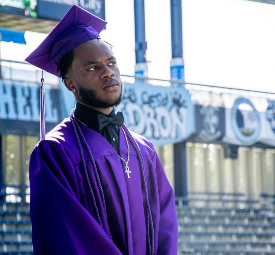 Kobe Thomas waits in line to pick up his diploma.