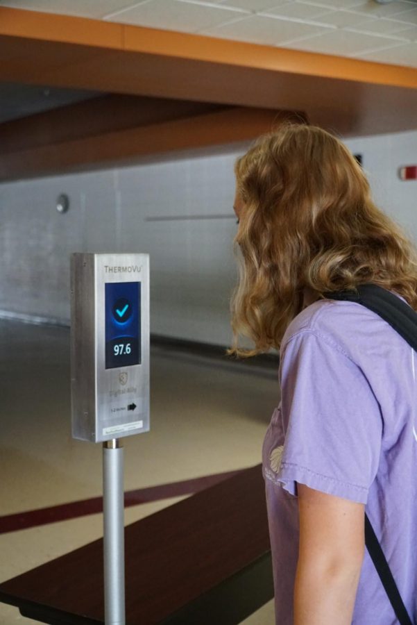 Junior Skylar Ryan checks her temperature before entering her cohort classroom.