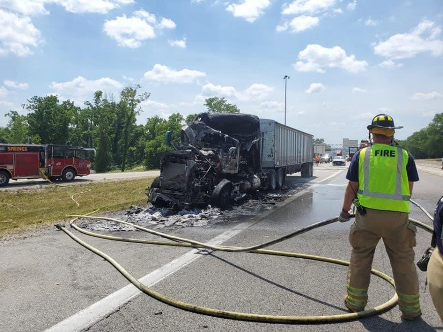 Reitemeier starts to put away the hose after stopping a diesel truck fire.