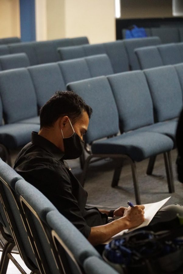 Male participant completes heath survey before the screening process begins. 