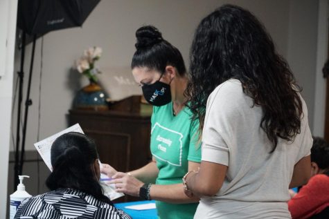 Ashely Adornante, Outreach Coordinator and BMI screener reads results off to a participant.