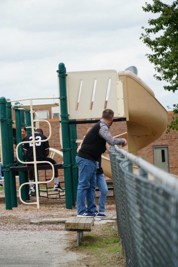 Fine arts teacher Randy Robertson stands next to playground during cohort break.
