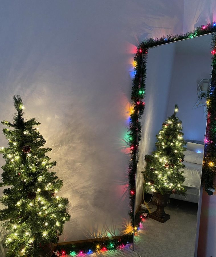 Junior Victoria LaRocca styles uses mirror to express her holiday decorations Dec. 1. The mirror makes an affect with the illusion of many trees. photo by Victoria LaRocca