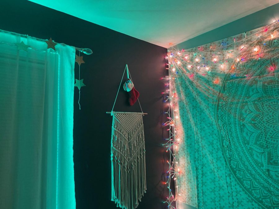 Freshman Layla Blankenship ties together everyday decor with Christmas lights Dec. 11. "I thought the green went well with the theme of Christmas and it looked good next to the red stocking and gold stars." Blankenship said.
photo by Victoria LaRocca