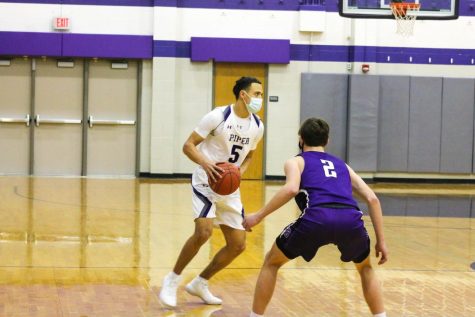 Dilyn Taylor-Cantu drives toward the paint against the Vikings.