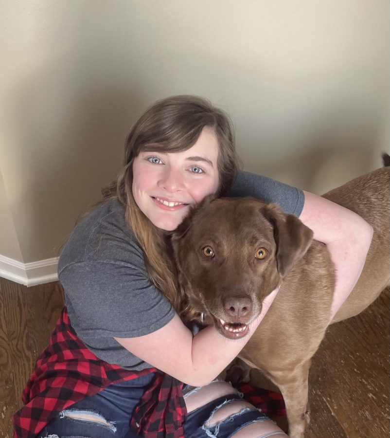 Junior Reagan Montgomery poses for a picture with her dog, Coco.