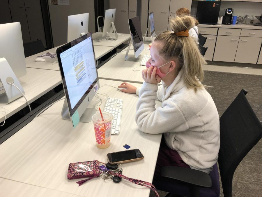 Senior Alexis Miles works on the yearbook after returning to school as a full-time, in-person student.