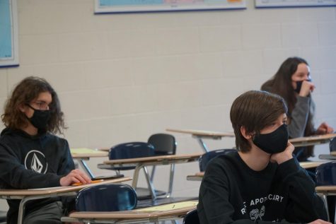 Freshmen Jack Wells, Alison Asbury, and Ethan Weber sit in class. 