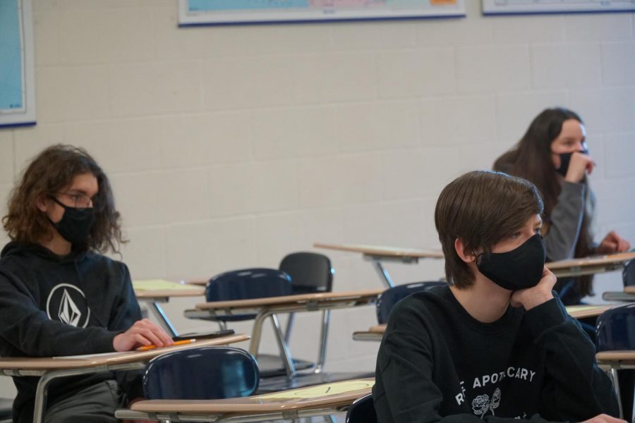 Freshmen Jack Wells, Alison Asbury, and Ethan Weber sit in class.