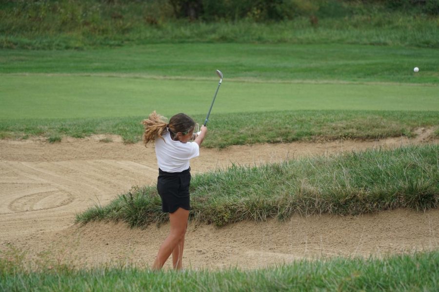 Sandy situation: Junior Tatum Vallejo, hits the ball out of a sand pit at the Falcon Lakes meet.