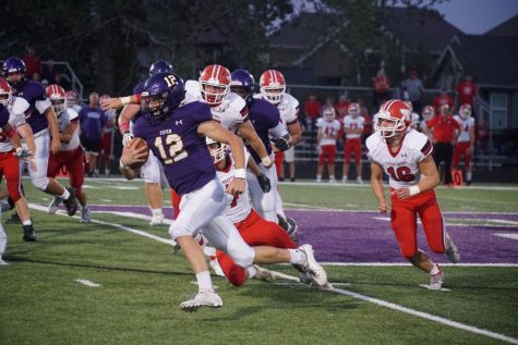 Senior quarterback Blake Porter runs the ball against the Tonganoxie Chieftains on Oct. 1. 