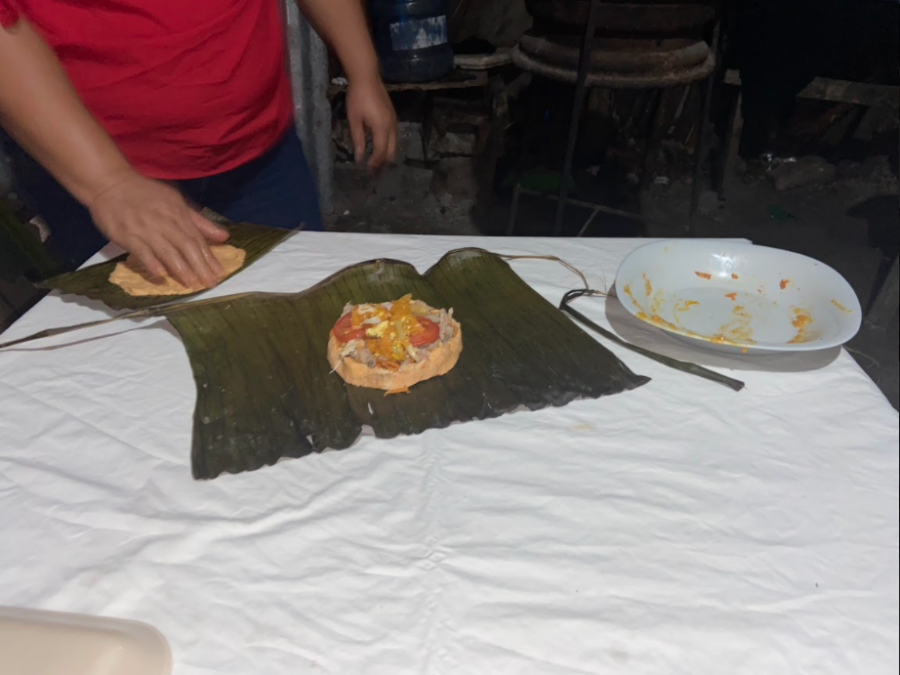 Local woman rolling maize to complete her Muc-bil Pollo before wrapping it in banana leaves.