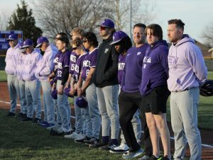 The baseball team stands together during the introduction of the Terri Beashore Cancer Awareness event.