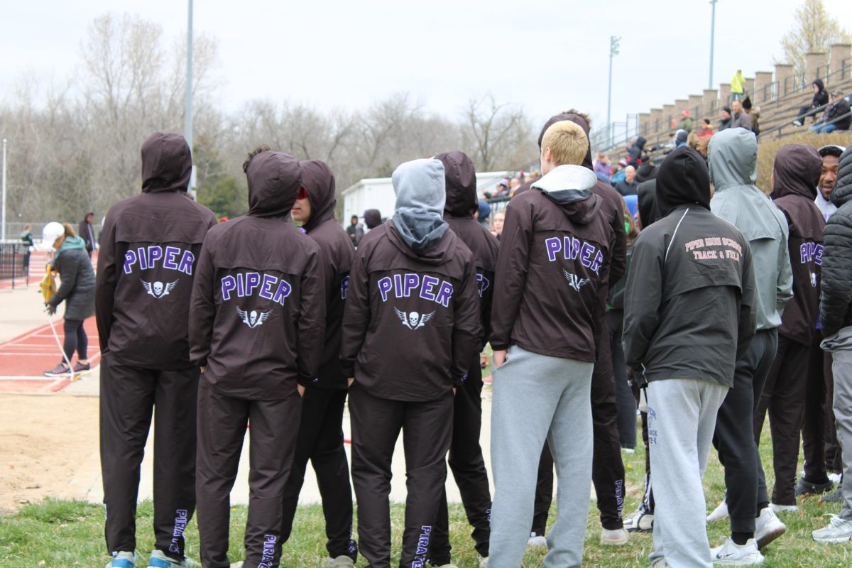 Team members gather at a track meet.